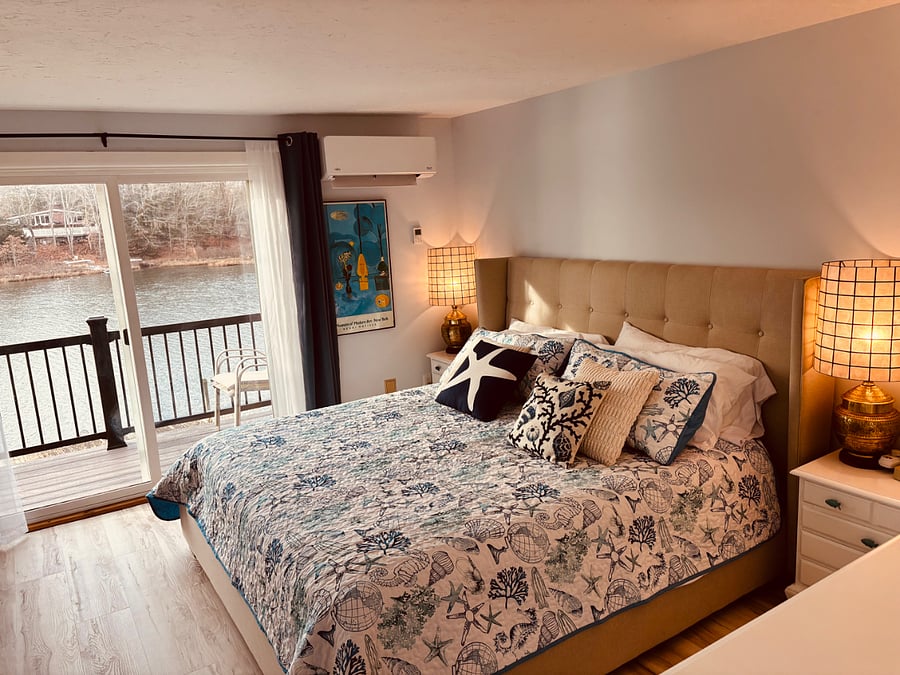 primary bedroom with balcony and water views, great to wake up to!