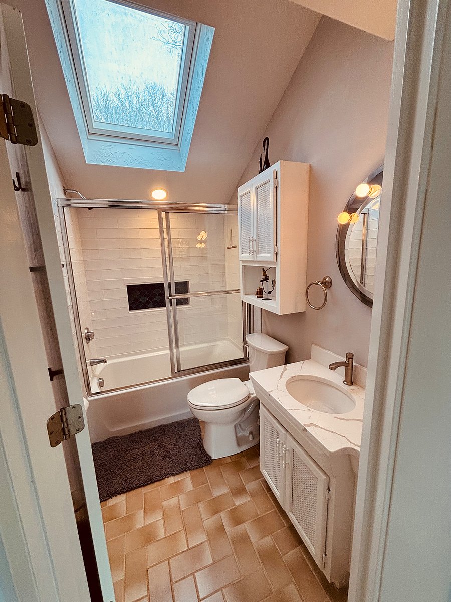 spa-like primary bathroom with skylight