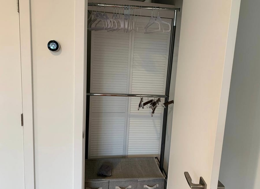 Closet with storage and hanging rack.