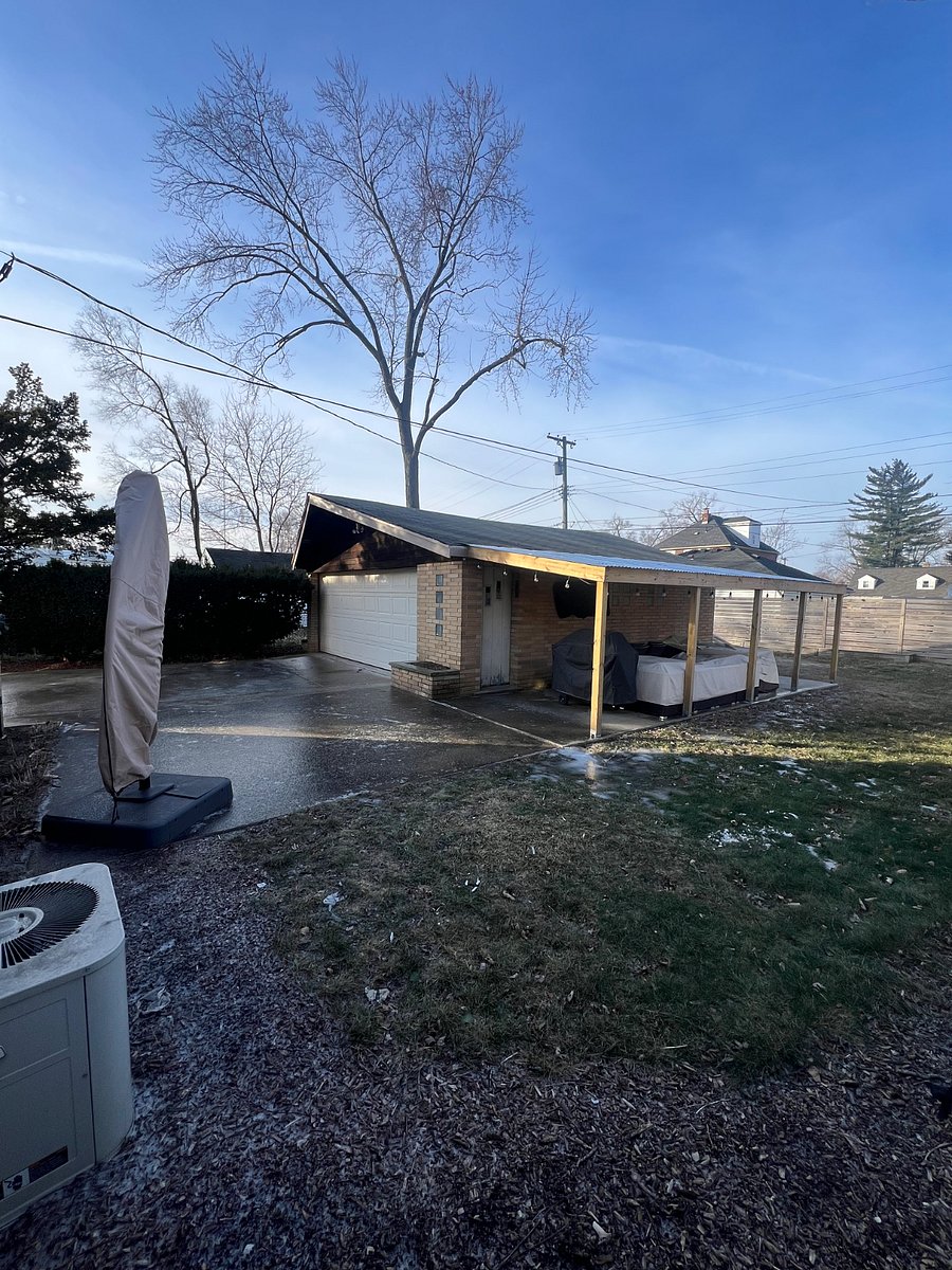 backyard with covered overhang, patio furniture and TV for hosting/relaxing.