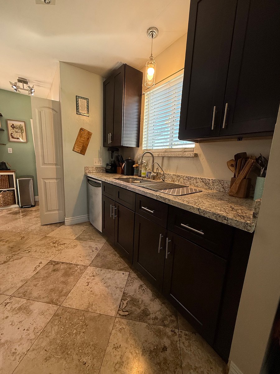 Granite countertops and lots of cooking utensils.