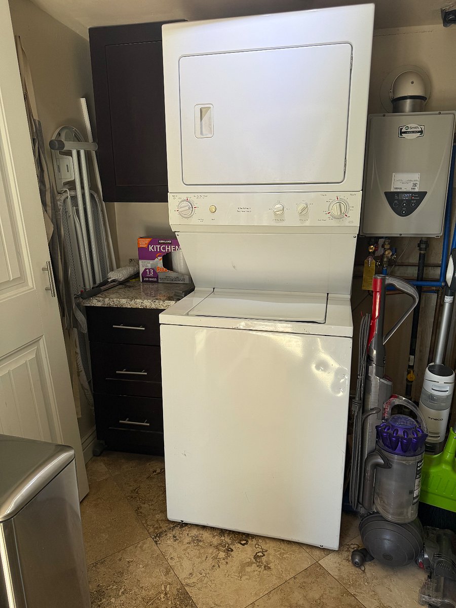 Washer and dryer and utility closet off the kitchen near the door to the back patio.