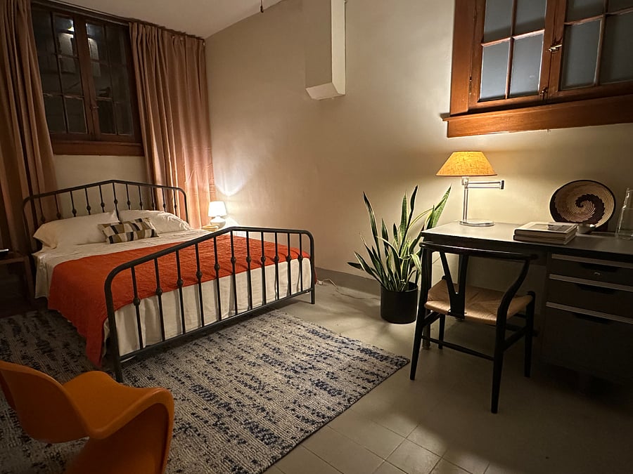 Cozy but spacious bedroom with desk.