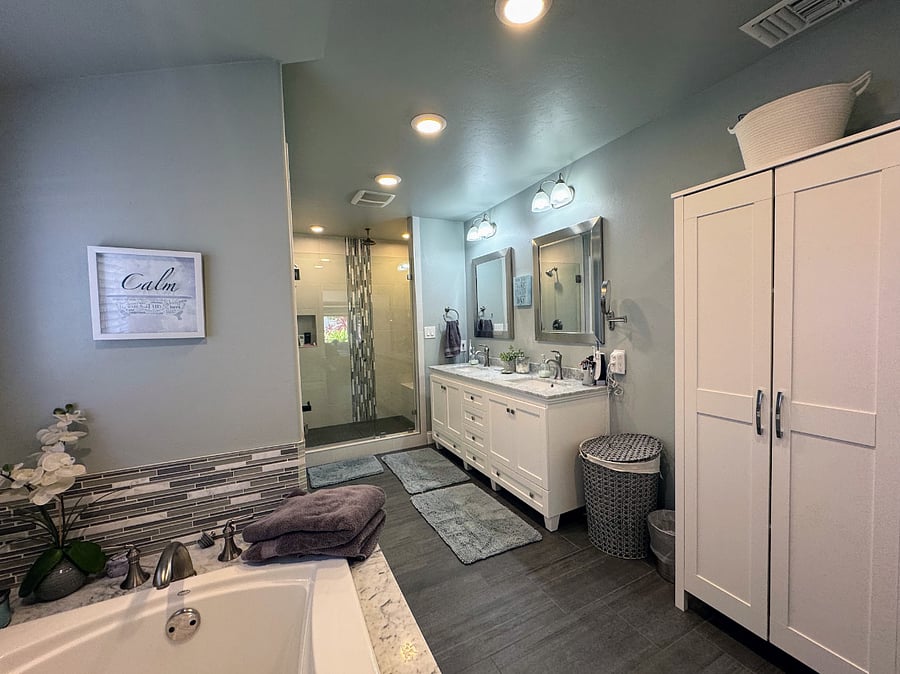 Primary bathroom with walk-in shower, large soaking tub, double vanity.