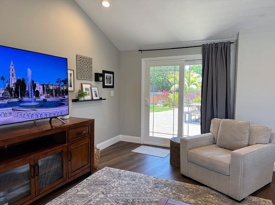 Comfortable club chair in great room. Easy access to the outdoor spaces.