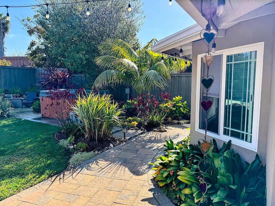 Garden oasis with mature landscaping and hot tub.