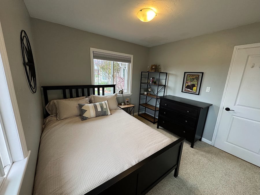 Bedroom with queen bed and ample storage.