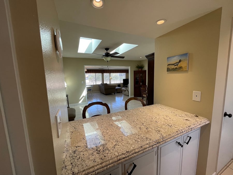 The breakfast bar uses the same granite as the kitchen countertops.