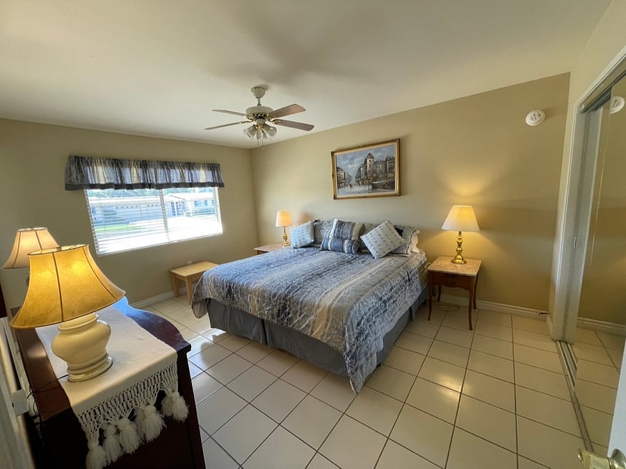 The primary bedroom features a king-size bed.
