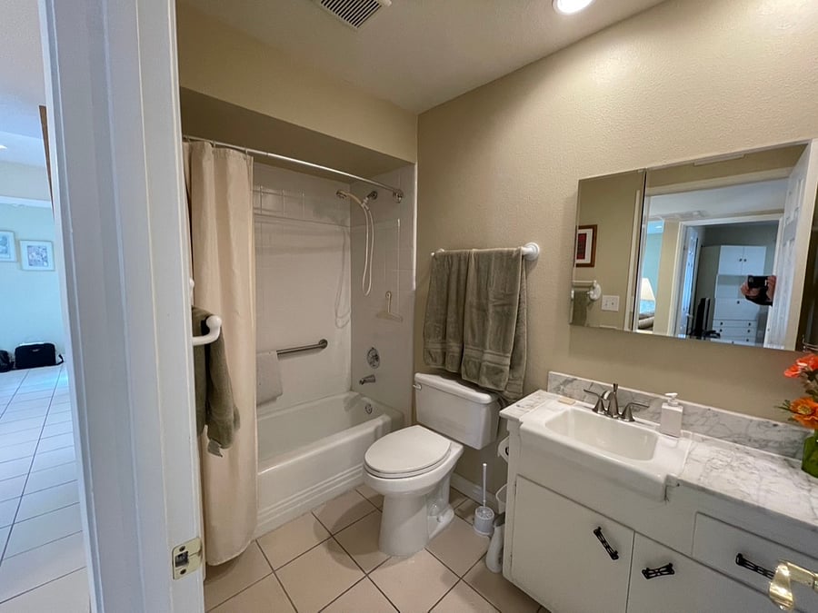 The guest bathroom offers a bathtub and a shower. Both bathrooms have genuine marble countertops.