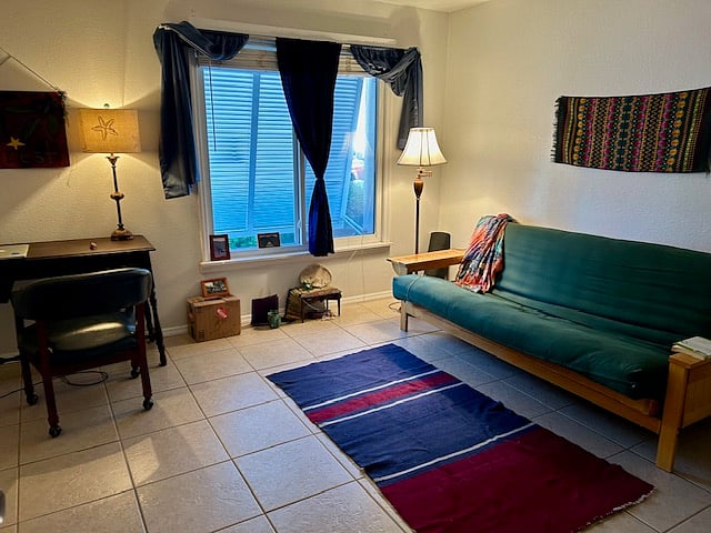 Front bedroom with double futon sofa/couch, can also be used as an office.