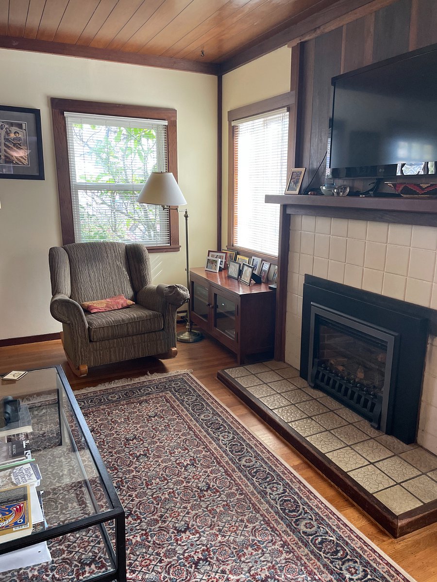 Comfortable chair to read it. TV above fireplace