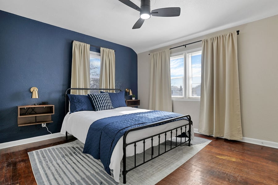 The "blue" bedroom with smart tv, blackout drapes, and white noise machine.