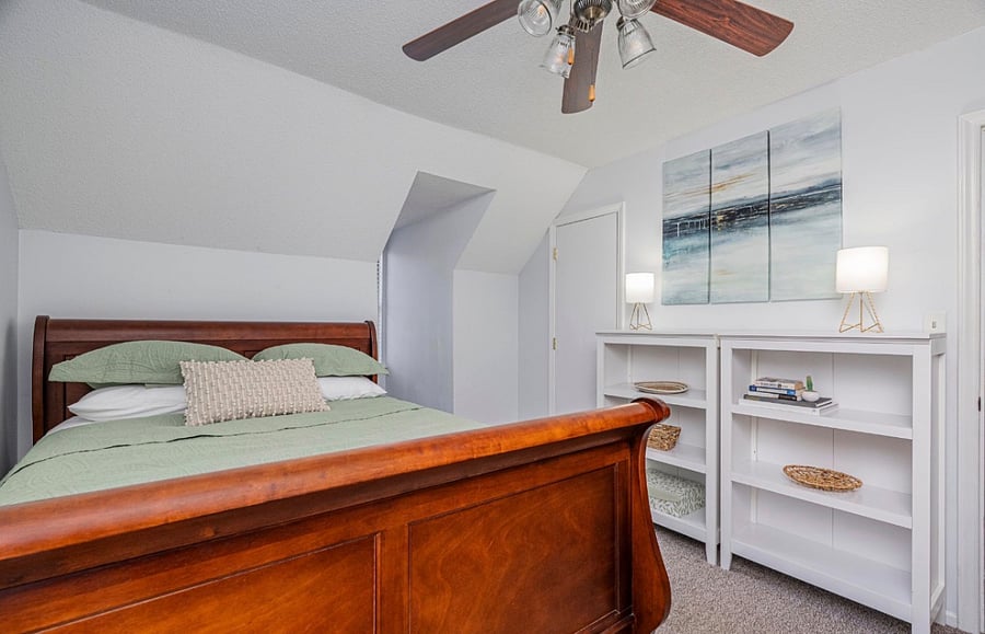Upstairs queen bedroom with walk-in closet, added a wall-mounted RokuTV in March 2026.