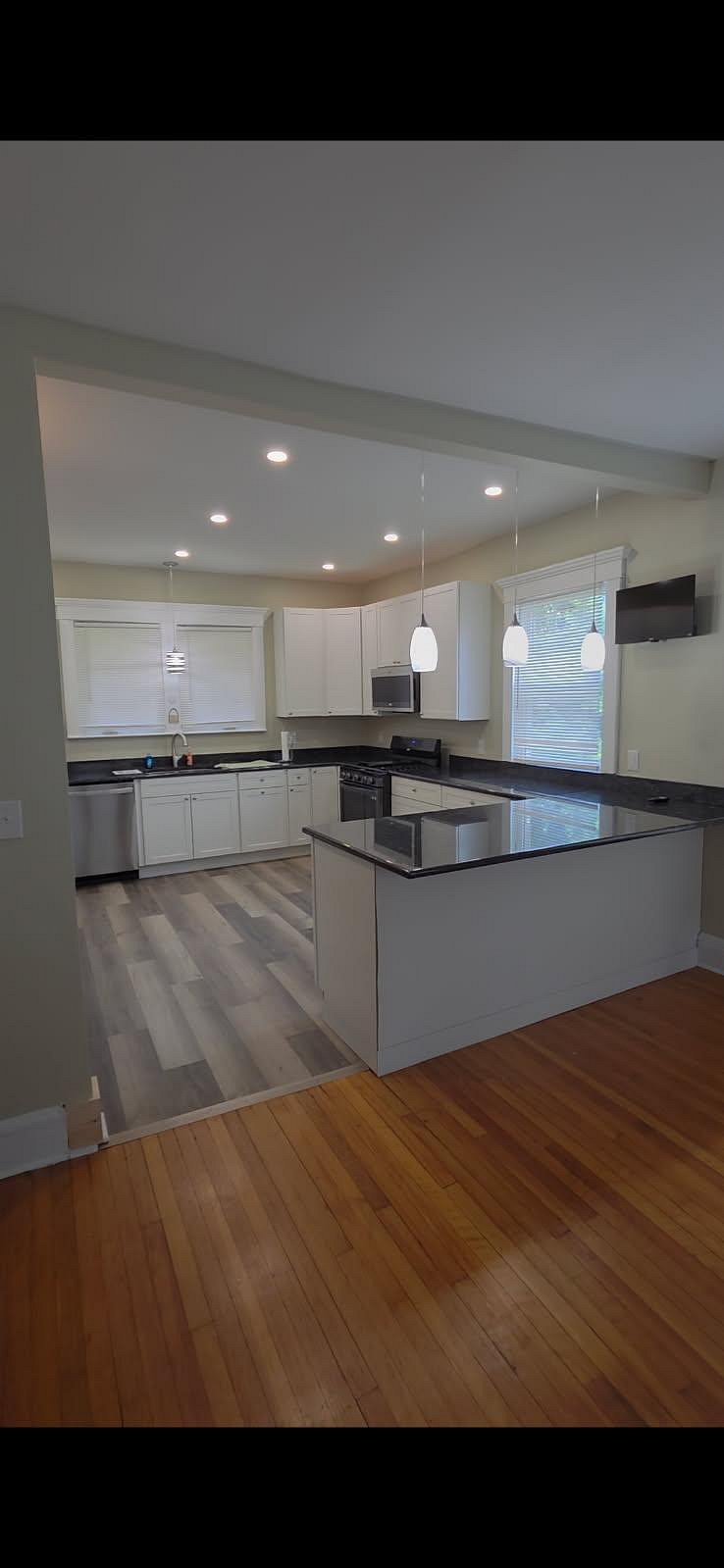 Lovingly renovated kitchen is complete with granite countertops & new appliances.