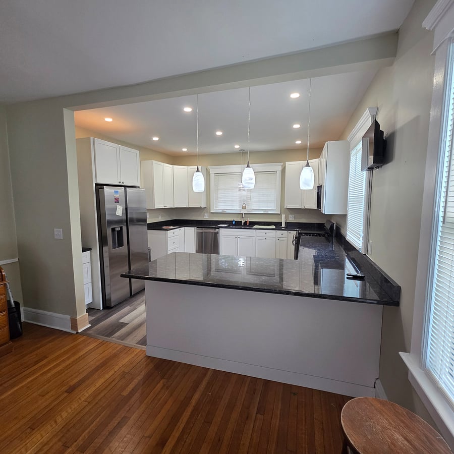 Lovingly renovated kitchen is complete with granite countertops & new appliances.