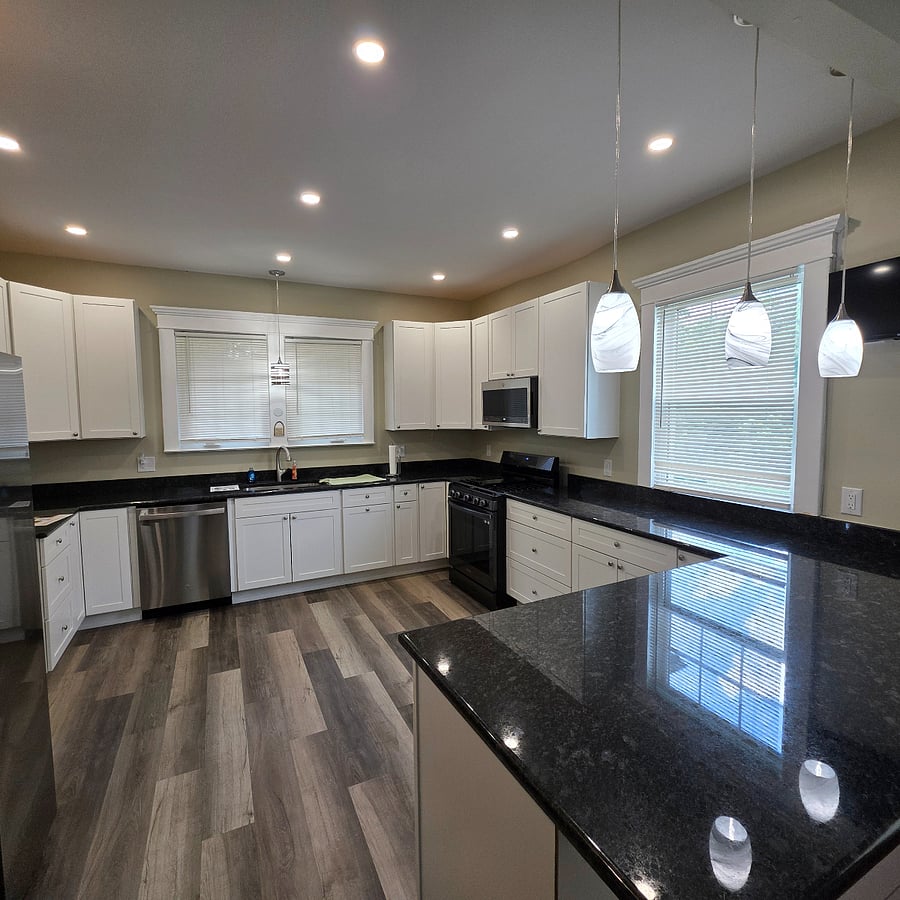Lovingly renovated kitchen is complete with granite countertops & new appliances.
