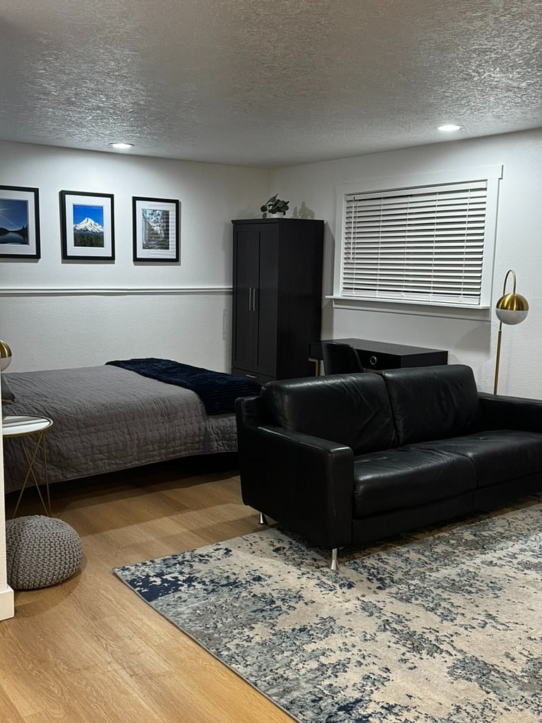 Large window that looks onto the back deck, yard and trees. New blinds to let sun in or keep it out. Desk and chair under the window for work or play.