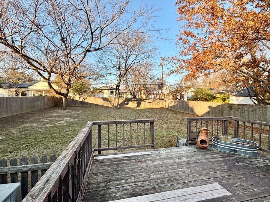 Fenced backyard with deck