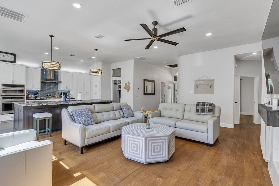 Top-of-the-line furnishings with leather furniture and open floorplan, high ceilings, and a beautiful panoramic view of the private backyard.