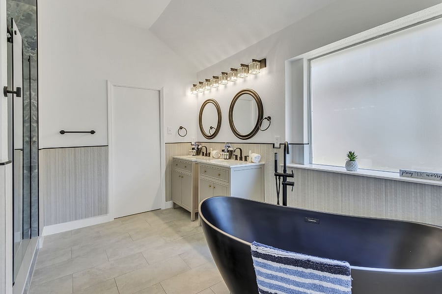 View of the master bathroom with free standing hollywood soaking tub and dual rain shower head walk in custom shower