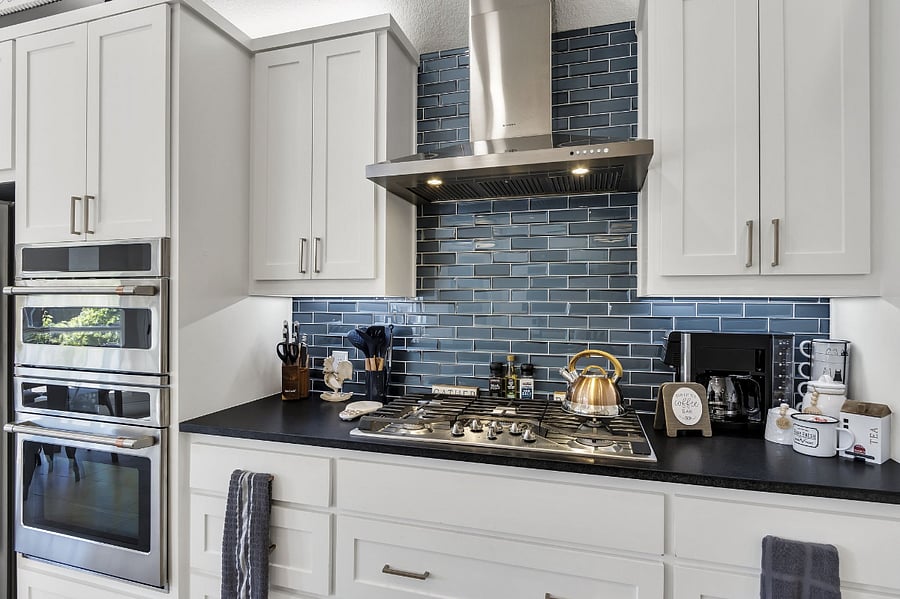 View of gas stovetop, coffee and tea service and Microwave/Oven GE Cafe appliances