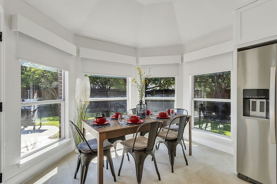 Dining room is open to the kitchen with a beautiful view of the private backyard.