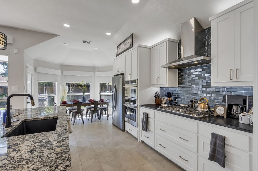 Chef's kitchen has GE Cafe appliances with a 12' granite island to prepare all kinds of family meals!