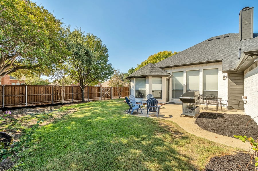 Backyard view of home with plenty of sun and shade trees!