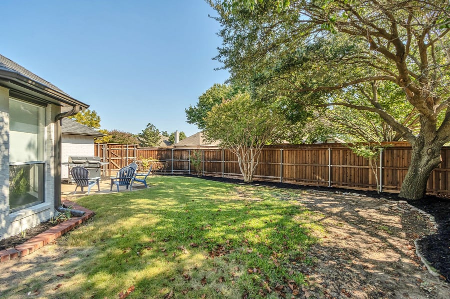 Backyard is around the back and side of the home for extra space with a very nice 8 ft privacy fence