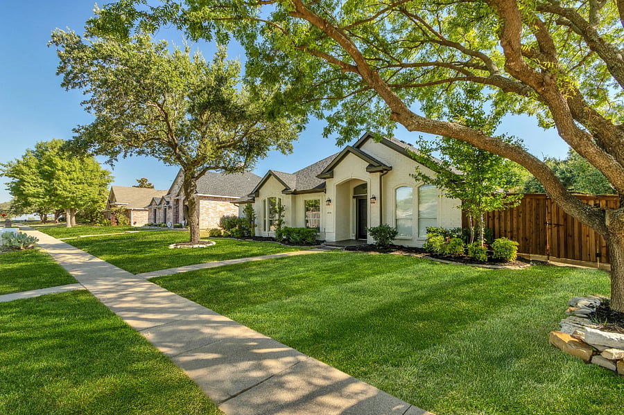 Large corner lot with large shade trees and curb parking in addition to rear entry 2 car garage