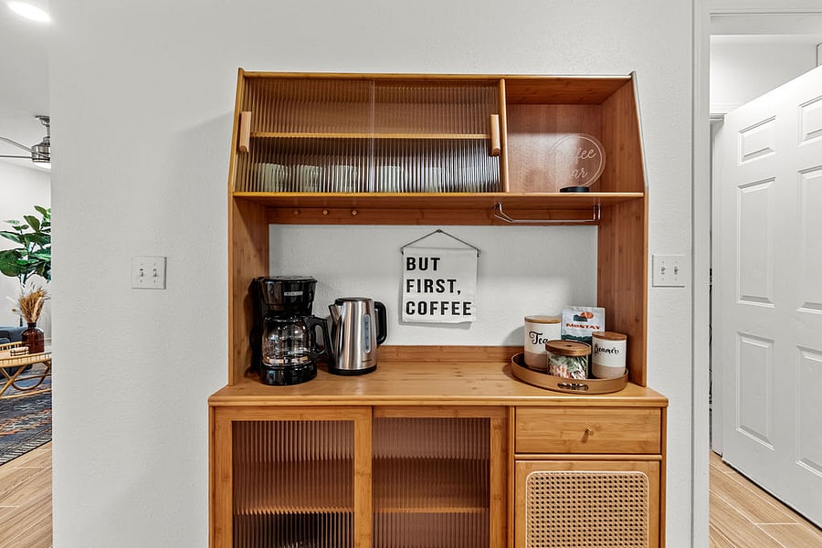 Coffee bar with drip coffee pot, hot water kettle, sugar, creamer, and select teas