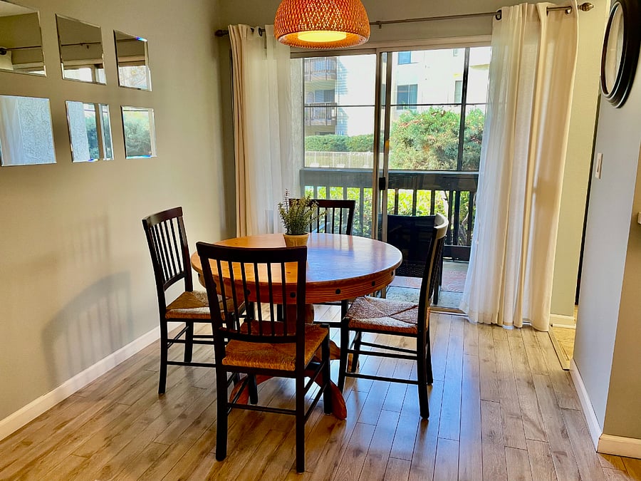 Dine with a view of the tree lined pool.