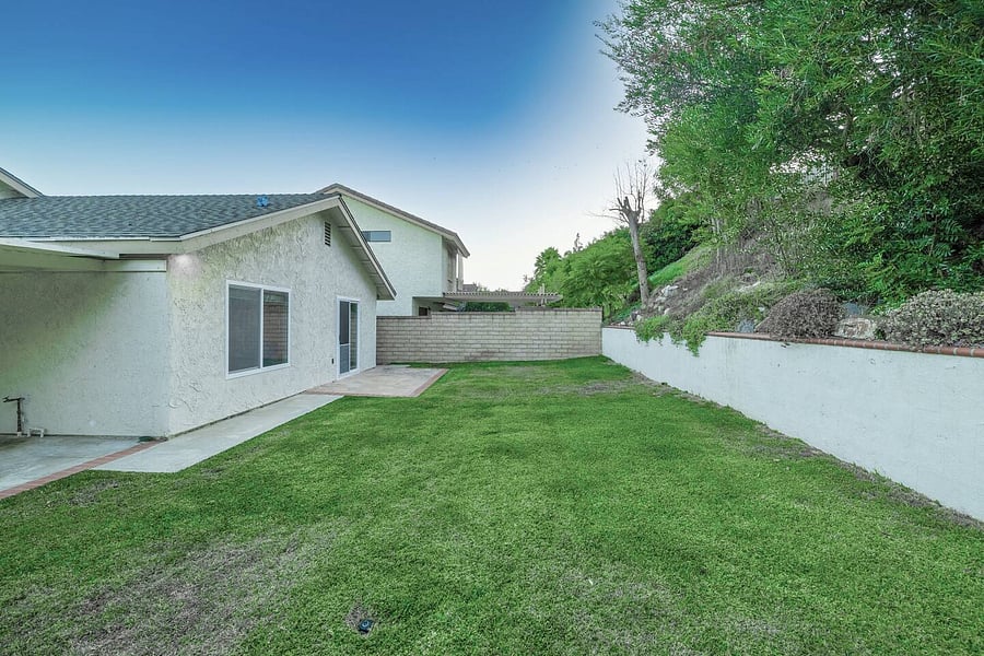 Enjoy this gorgeous fenced in backyard with green lawn