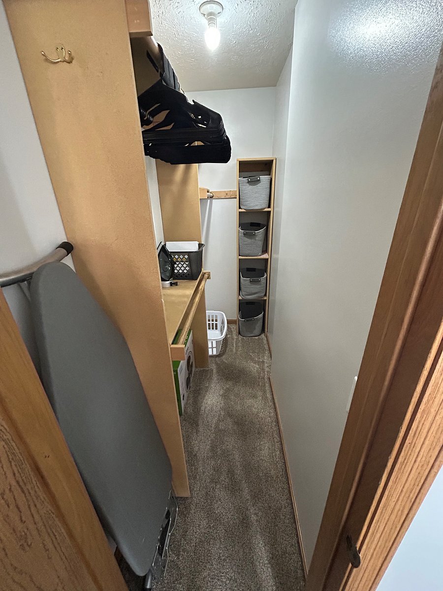 Walk in closet with storage baskets, hangers, full size ironing board & iron, laundry basket, oscillating fan, and extra bed sheets
Not Pictured: vacuum