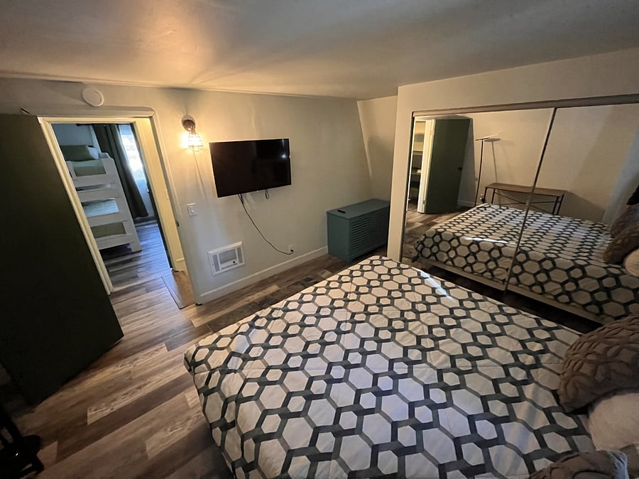 Bedroom with a king bed and a smart TV.
