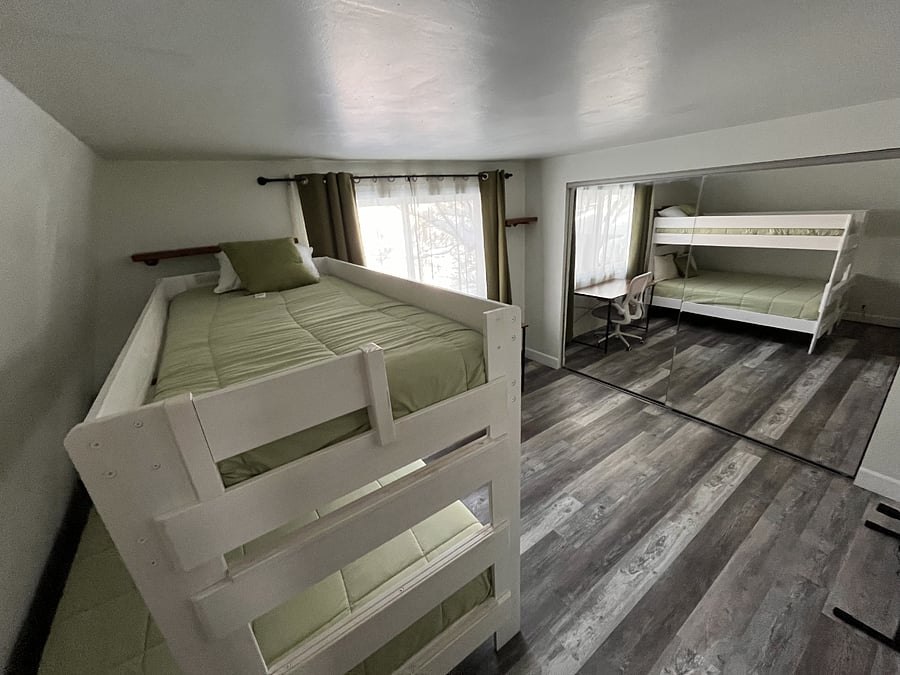 Bedroom with a bunk bed. {A Queen and a twin bed}.
