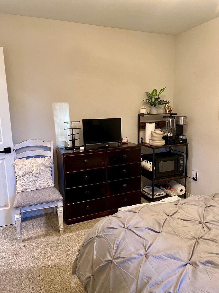 Private bedroom includes dresser and small kitchenette