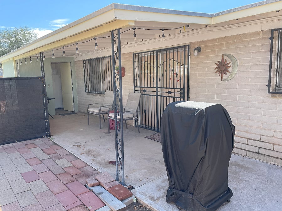 Back door leading to a small porch, laundry room, barbeque grill and picnic table. Also have two chairs and a table for relaxation.