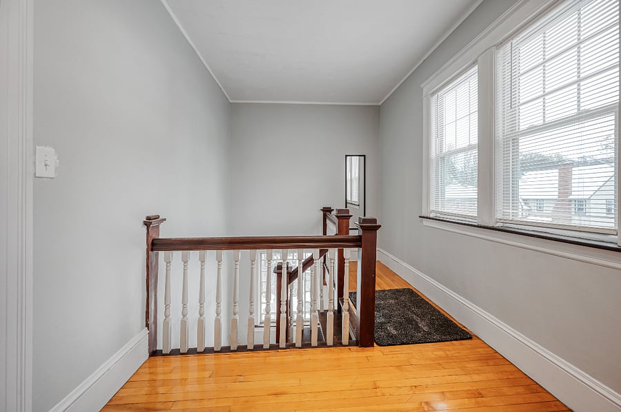 Staircase leading to private entryway located at front of home