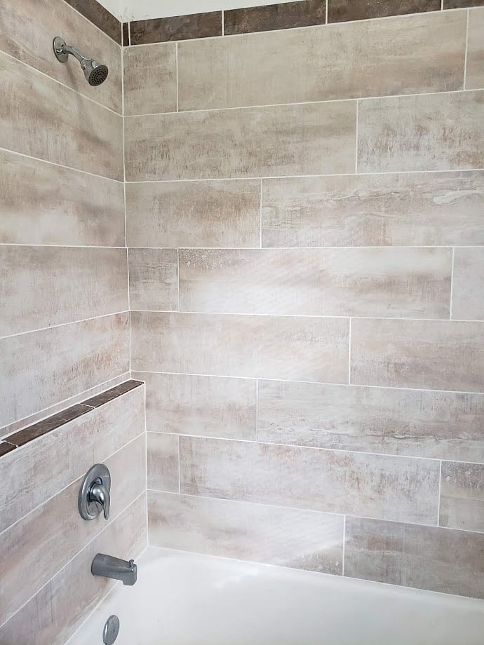 full tub and shower with tile