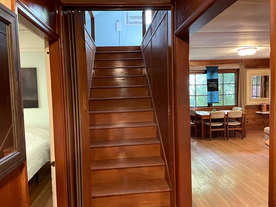 Stair case up and a kitchen table in the background 