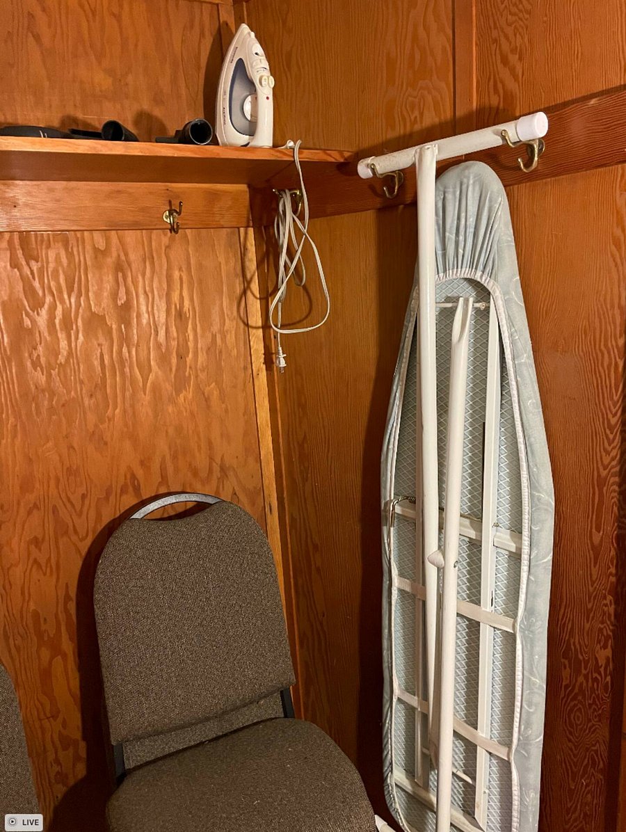 Huge walk-in closet with Iron board, etc