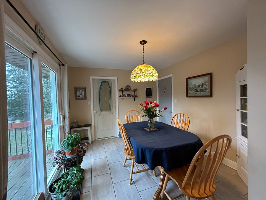 Kitchen eat-in area (laundry room behind the door with the ironing board)