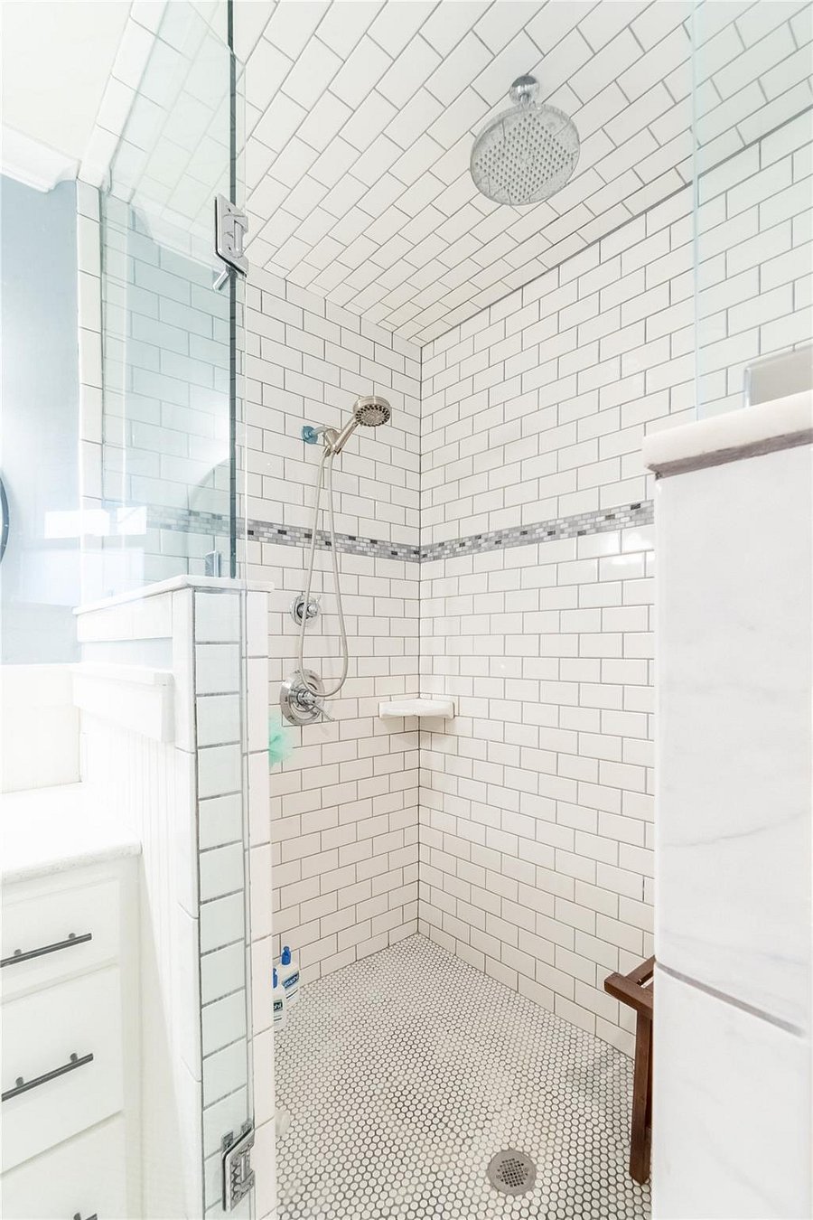 Extremely spacious and rainfall shower with multiple heads.