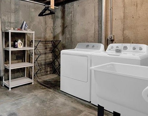 The laundry room is located in the lower level of the home adjacent to the
Family room. You can watch TV or play games while you do your wash. An iron, mid sized ironing board, clothes drying rack, and starter laundy supplies are all located here.