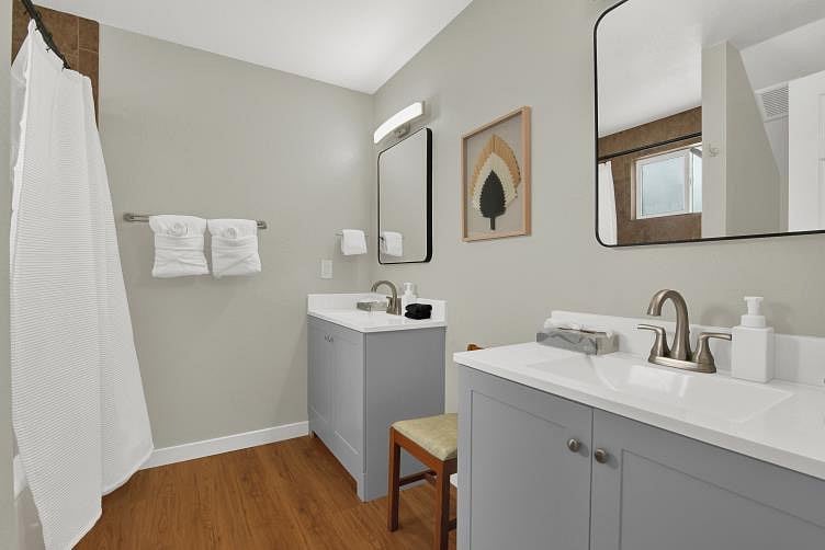The Primary bathroom has two vanities with their own starter supplies of soap and tissues. It also comes with towels, as well as black make-up wash rags.