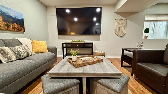 Oversized coffee table doubles as a game table with roll out benches, with 86 inch Smart TV ready for movie night!