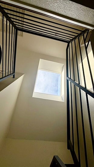 Ou art shot- from the lower level stairway to the skylight on the second level.
