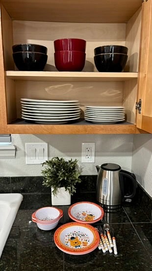 Dishes and bowls stored just above the dishwasher.